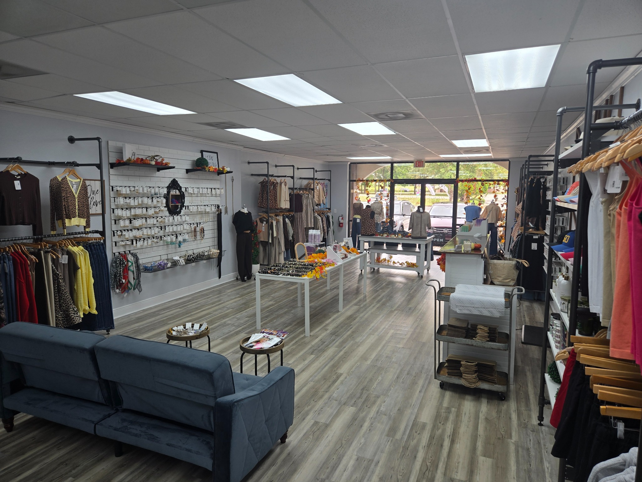 Inside Dovie’s Boutique, with clothing racks, jewelry displays, and a welcoming seating area